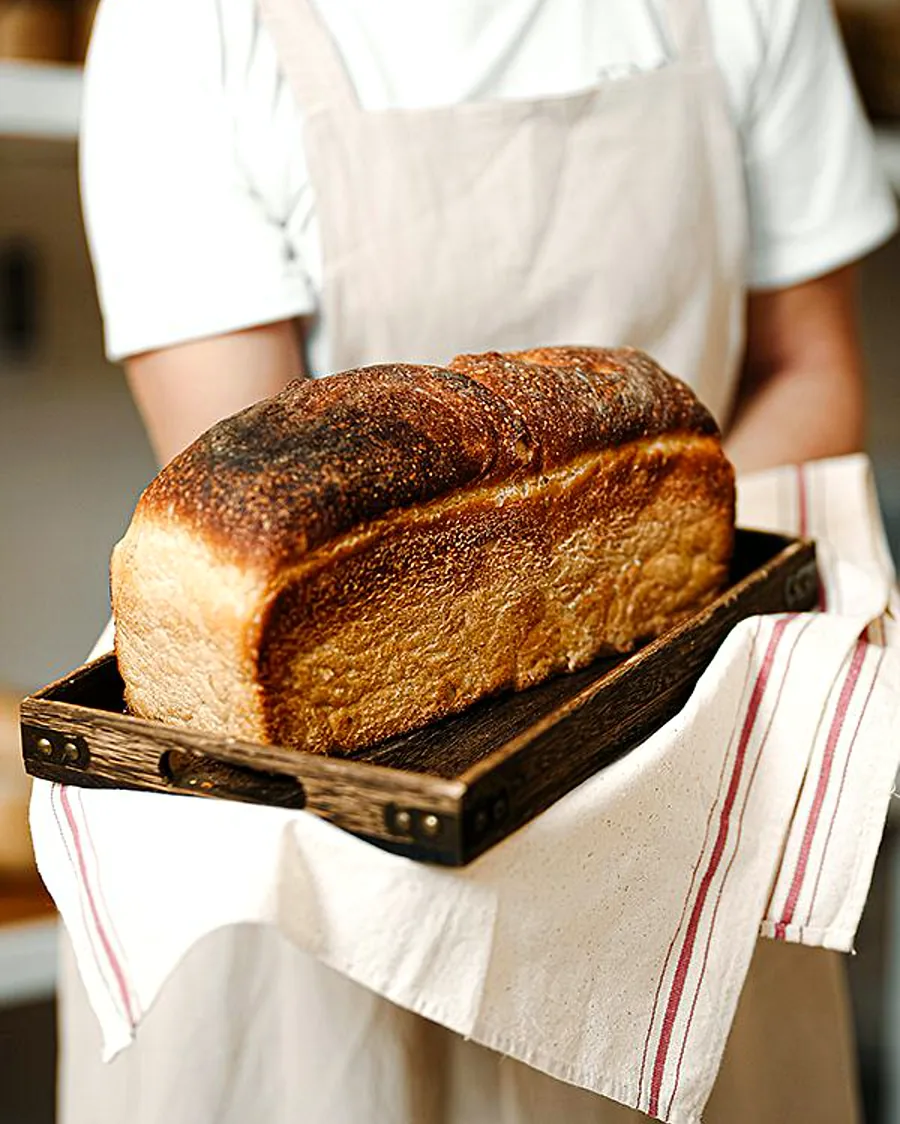 Upright portrait of a finished Japanese soft bread loaf