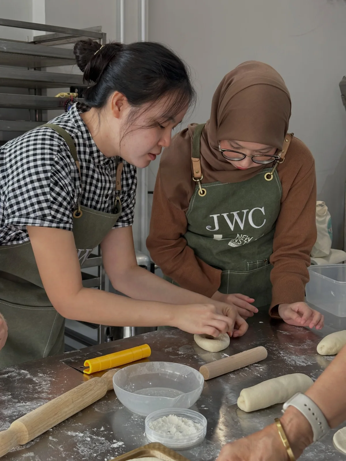 Siew Wei guiding a learner during hands-on dough shaping in the real BWC classroom