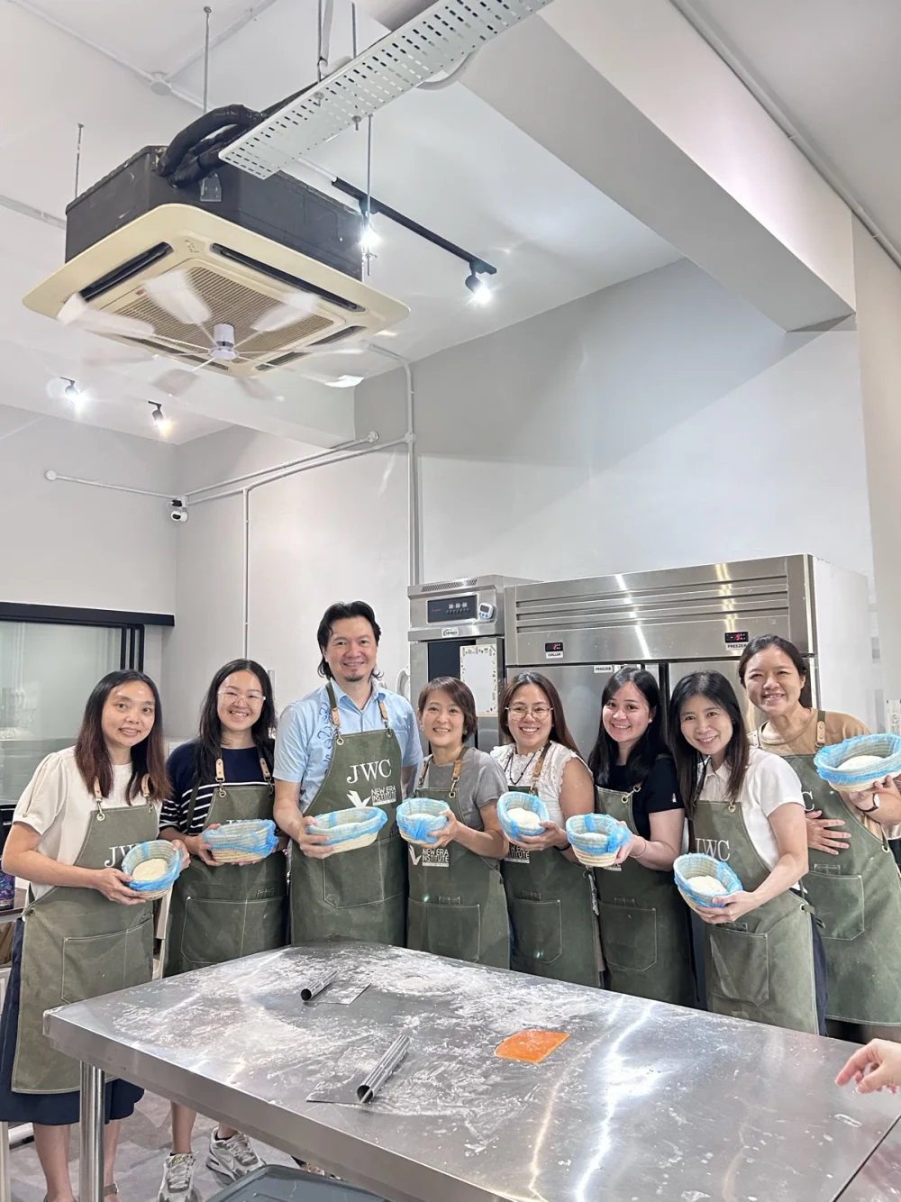 A real BWC class group holding sourdough proofing baskets