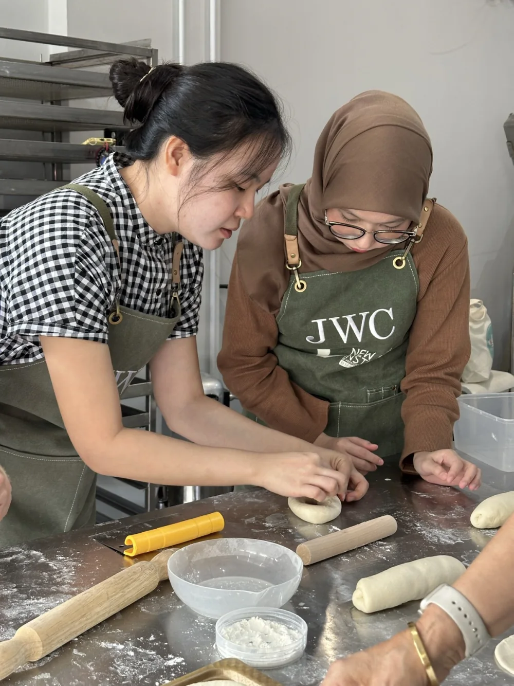 Siew Wei demonstrating bread shaping beside a BWC learner