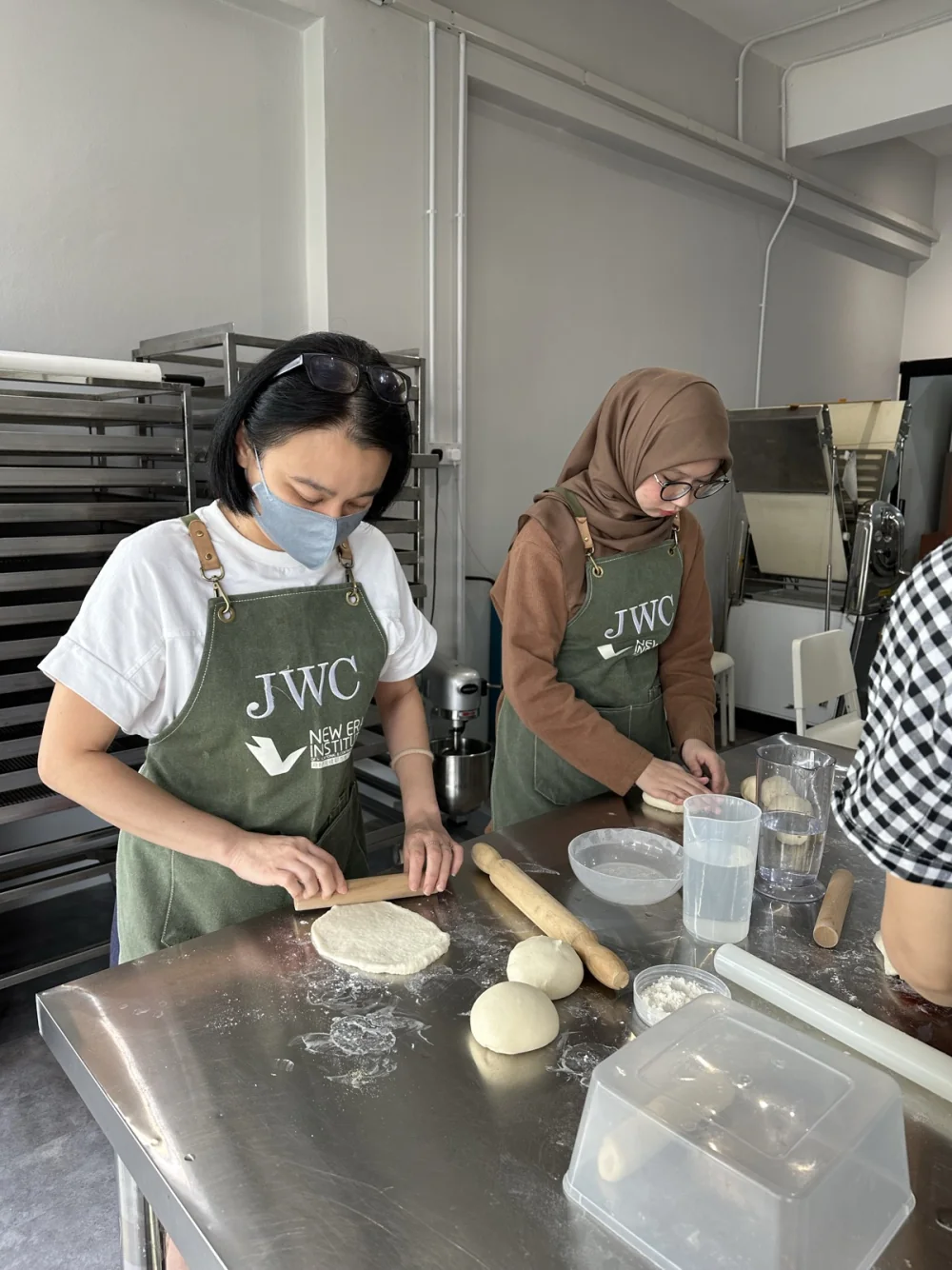 BWC learners rolling and handling dough at the classroom bench